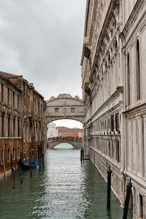 Bridge of Sighs Venice, Italy viewed looking down the canal towards the lagoon with the Doges Palace on the right on a cloudy dayのeditorial素材