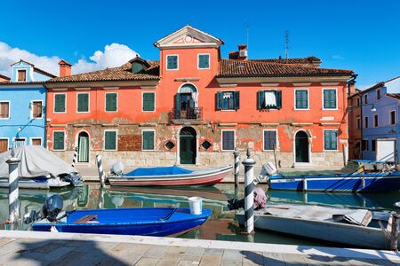 Street scene with a canal and moored boats in Burano, Italyのeditorial素材