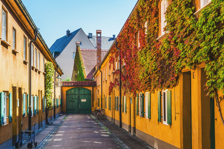 Augsburg, Germany - September 08, 2016: Colourful yellow buildings in Fuggerei, Augsburg, Germany lining a central courtyard, one of the oldest social housing complexes in the worldのeditorial素材