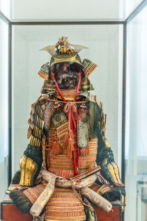 Augsburg, Germany - September 08, 2016: Helmet and chest portions of ancient Asian warrior armor on display in museum case indoors in Germanyのeditorial素材
