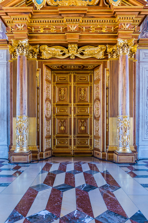 Augsburg, Germany - September 08, 2016: Floor and door detail of the Golden Hall in the town hall Augsburg showing the inlaid stone leading to ornate doors with columns and architraveのeditorial素材