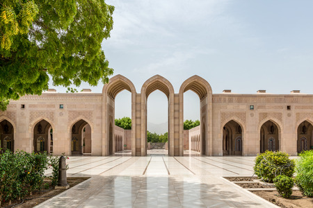 Beautiful empty courtyard with arched stone entry way with reflective walkwayの写真素材