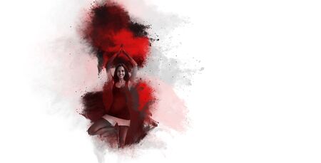 Colorful explosion of vivd red Holi powder or pigment in an artistic pattern on a textured white paper background with copy spaceの写真素材