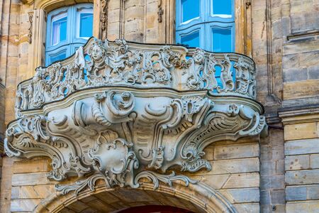 Ornate historic Baroque carved stone balcony on the exterior facade of an old building in Bamberg, Germanyのeditorial素材