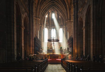 Light streaming through the windows of Bamberg Cathedral, Germany lighting up the altar in a spiritual sceneのeditorial素材