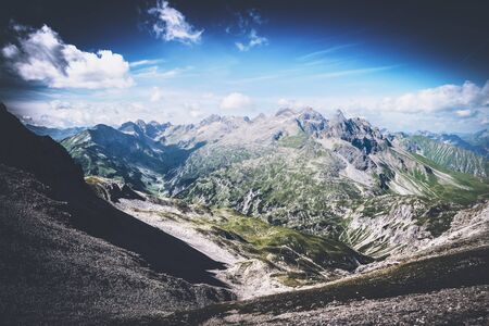 Beautiful from above on mountain valley with vignette sky near Oberstdorf, Germany. The famous Heilbronn via ferrata runs on the line.の写真素材