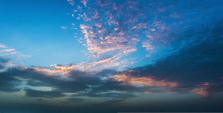 Pretty pink clouds during the blue hour in a tropical sunset in a weather and nature backgroundの写真素材