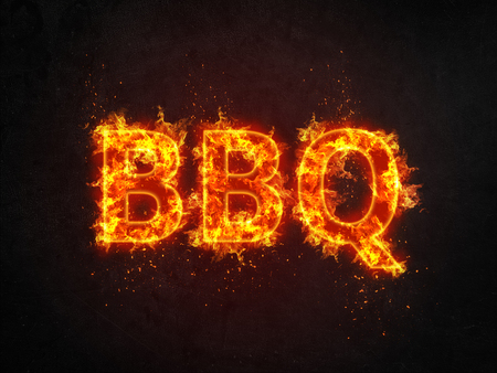 Burning BBQ sign with flaming letters and showers of fiery sparks over a black background with copy spaceの写真素材