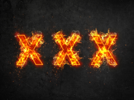 Three burning crosses or Xs in a row consumed by fiery orange flames over a textured grungy grey background with copy spaceの写真素材