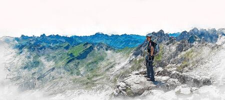 Panorama banner of a mountaineer standing on a summit of a mountain surveying the rugged peaks and valley belowの写真素材