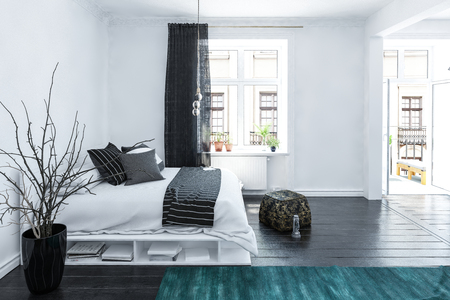 Large spacious grey and white bedroom interior in a luxury home with a stylish storage bed, accent black pouffe,cushions and drapes on a wooden floor with bright light windows, 3d renderingの写真素材