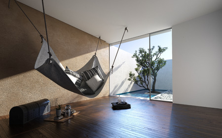 Hammock hanging from the ceiling in a minimalist living room in a modern home with glass door to exterior walled patio. 3d renderの写真素材