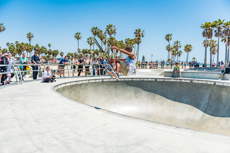 LOS ANGELES, USA - May 15 2018: Venice Beach outdoor skate park with skateboarders and a group of people watching them perform stunts in Santa Monica, Los Angeles, Californiaのeditorial素材