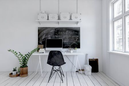 Modern monochromatic white office with blackboard above a small writing table with desktop computer...