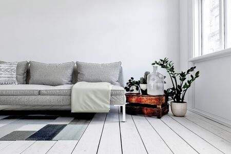 Digital render of modern grey couch in front of white wall next to rustic wood crate and small plant in pot. 3d renderingの写真素材