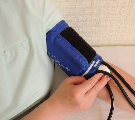 Measurement of blood pressure.  Device for measuring blood pressure on the arm of the woman.