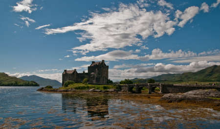 Eilean Donan Castle reflecting in Loch in Summer, Scotlandのeditorial素材