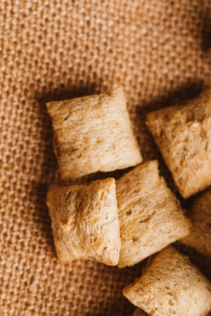 cereal pillows with chocolate filling on sackcloth background.