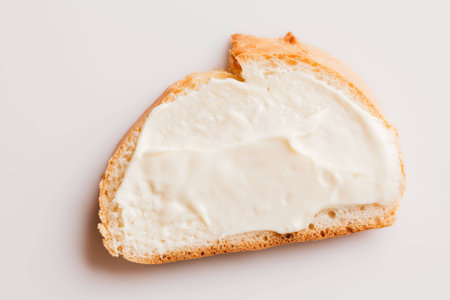 sandwich with creamy melted cheese close-up on a light background.