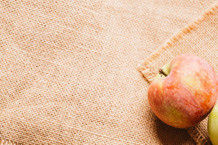 several fresh red apples on sacking background.の写真素材