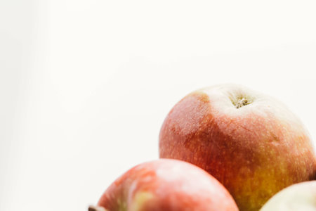 fresh red apples on a light white background.の写真素材