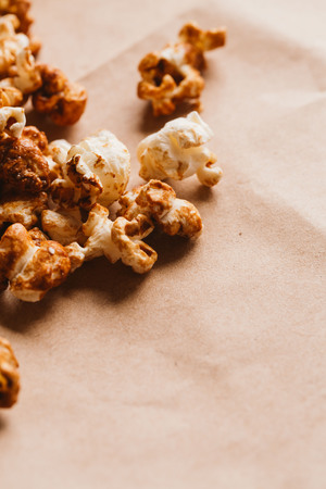 sweet caramel popcorn close-up on light paper.の写真素材
