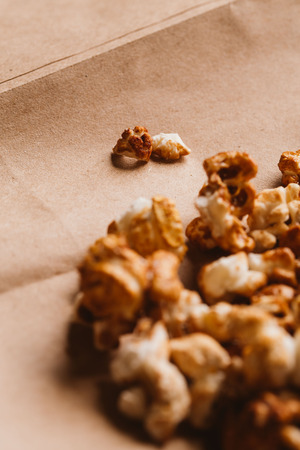 sweet caramel popcorn close-up on light paper.の写真素材