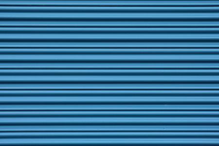 Corrugated metal sheet door in blueの写真素材