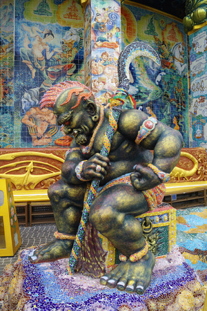 Sculpture of giant guard goddess sitting on top of tressure boxのeditorial素材