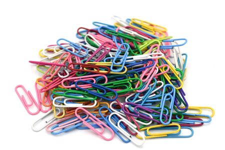 Paper clips isolate on white background.Paper clips is a device used to hold sheets of paper together, usually made of steel wire bent to a looped shapeの写真素材