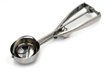 Ice cream scoop.A kitchen utensil that is made to form ice cream into a slightly rounded or a well-rounded ball shape.の写真素材