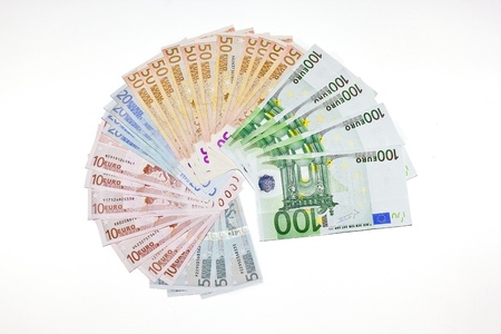 euro banknotes spread out on a white background