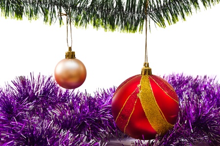 Christmas balls on a green branch on white backgroundの写真素材