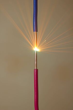 bright flash of short-circuit and flying sparksの写真素材