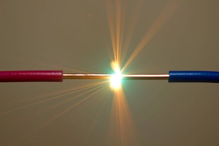bright flash of short-circuit and flying sparksの写真素材