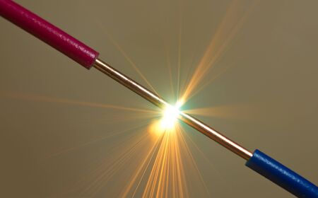 bright flash of short-circuit and flying sparksの写真素材