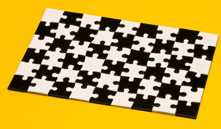 black and white puzzles on a yellow background