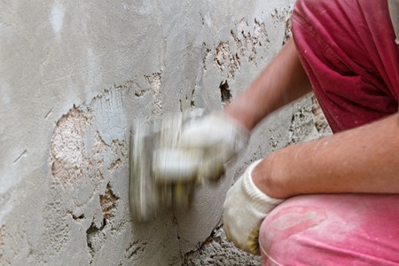 Master produces grout plaster using a graterの写真素材