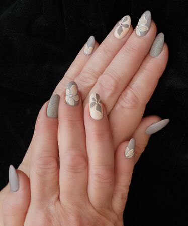 Female hands with a multicolored manicure closeupの写真素材