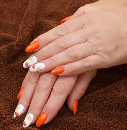 Female hands with a multicolored manicure closeupの写真素材