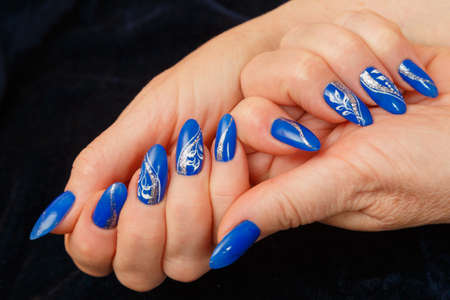 woman's hands with a manicure on a black backgroundの写真素材