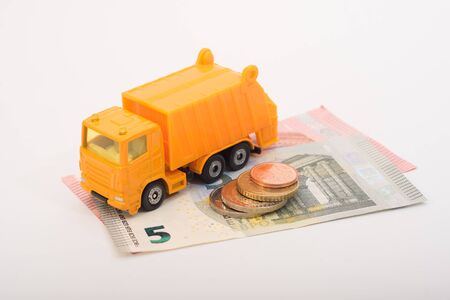 Toy garbage truck with coins and euro notesの写真素材