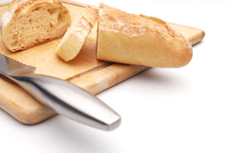 Sliced white bread on a wood cutting board, white background