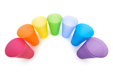 Group of bright plastic cups, rainbow colors, white backgroundの写真素材