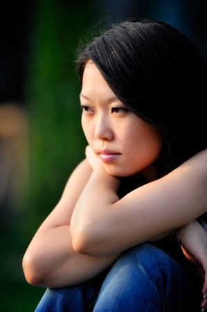 Young asian woman portrait, natural blurred backgroundの写真素材