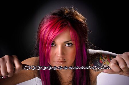 Attractive young brunette girl posing with handcuffsの写真素材