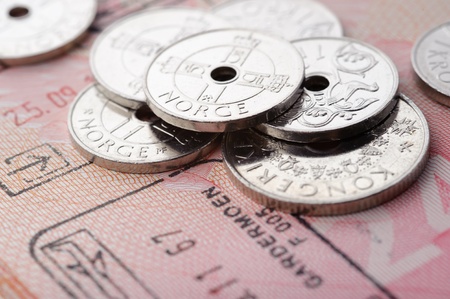 Norwegian krone coins and passport page with border stampの写真素材