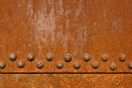 Backgrounds and textures: rusty metal surface with riveted joints, industrial abstractの写真素材