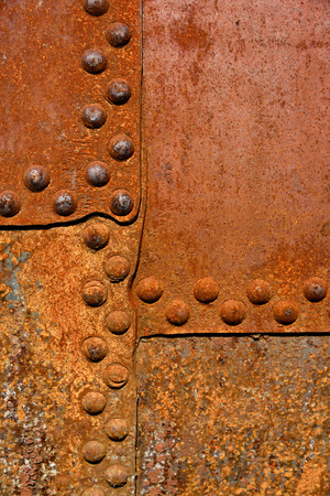 Backgrounds and textures: rusty metal surface with riveted joints, industrial abstractの写真素材