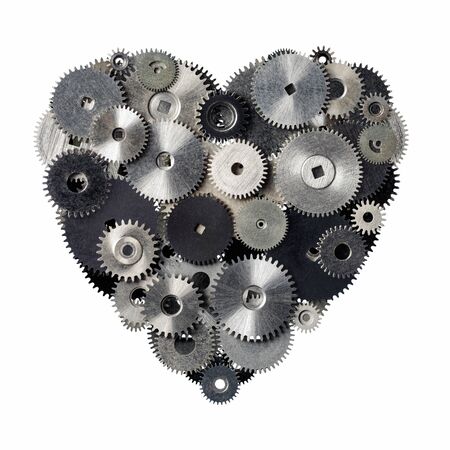 Isolated objects: heart shape made of metal pinions and sprockets, isolated on white background. Technical abstract for Valentines day or any other romantic event. Rust and scratches on metal are kept intentionally.の写真素材